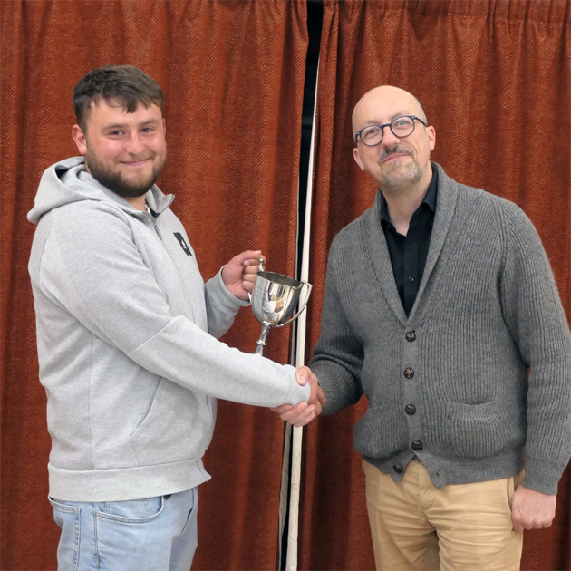 Best new player receives trophy from President