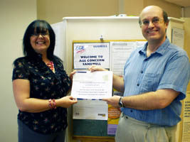 Andrew Farthing presents cheque for £650 to Age Concern Sandwell's CEO Julie O'Toole