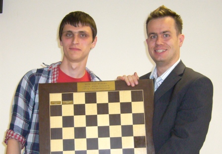 Director Andrew Moore (right) presents Pavel besedin (Latvia) with the Open championship prize.