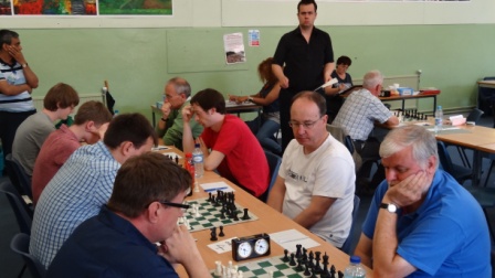 Andrew Moore standing surveys the Open Tournament