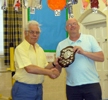 President Maurice Bissell presents the Division 2 shield to Mark Hore of Headless Cross