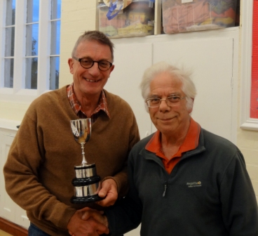 Tony Shaw, left, receives the Ball Cup trophy from President Maurice Bissell